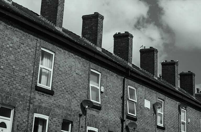 A black and white photo of a block of terraced houses