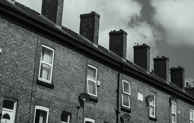 A black and white photo of a block of terraced houses