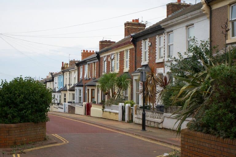 A row of terraced houses with small front gardens